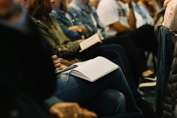 A woman taking notes at a conference